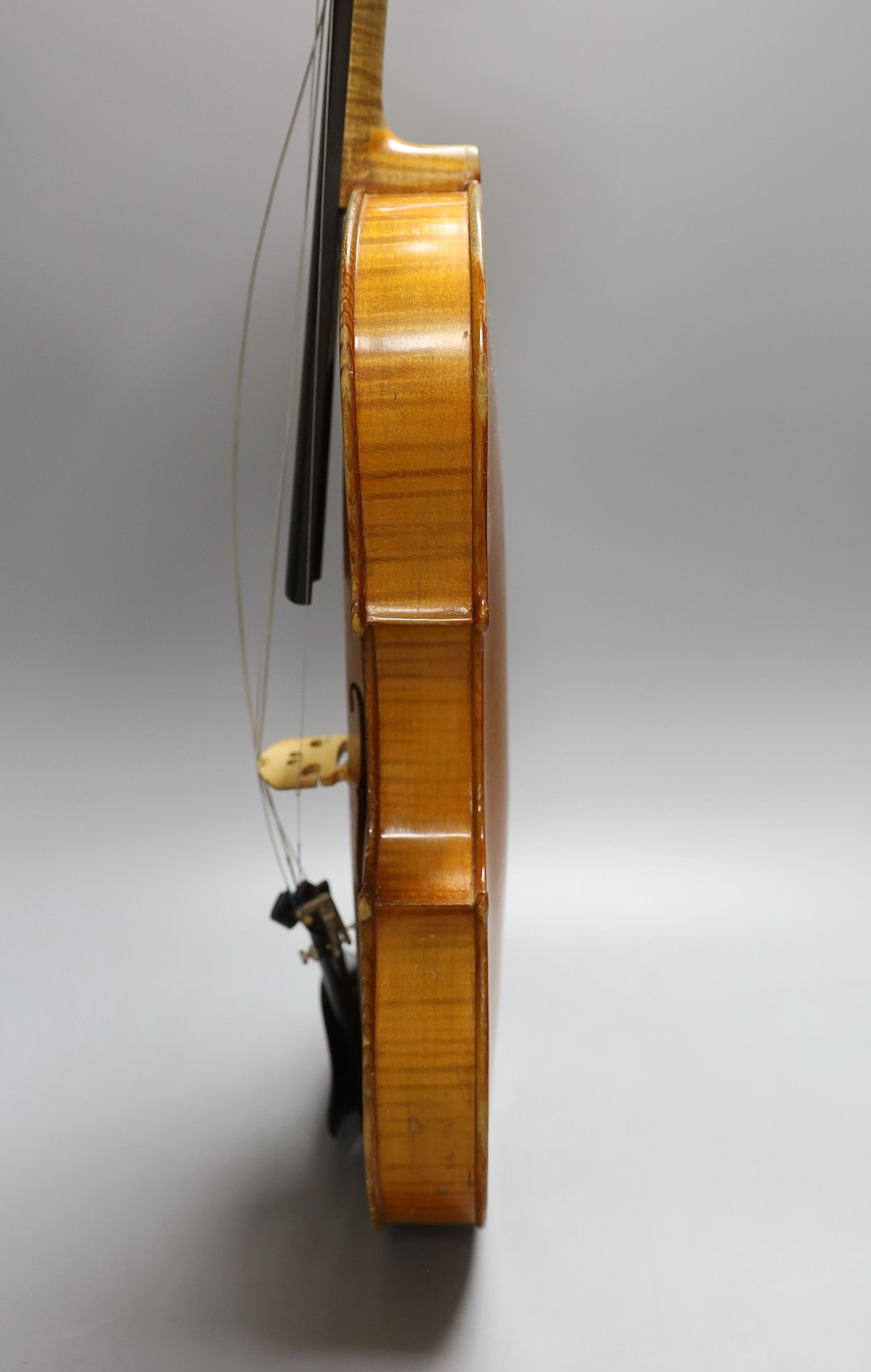 A 20th century violin in case with two bows, length of back 35.5cm